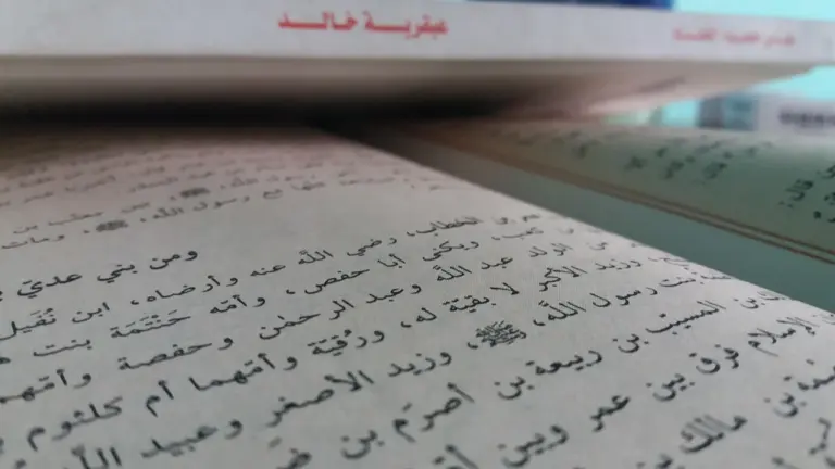 Close-up of an open book showing Arabic script on its pages.