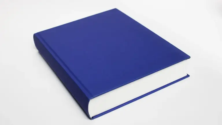 A blue hardcover book resting on a white background