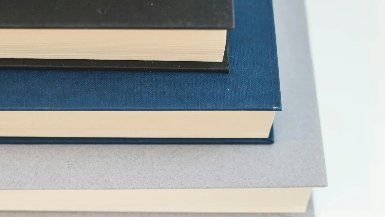 Stack of hardcover books with blue covers