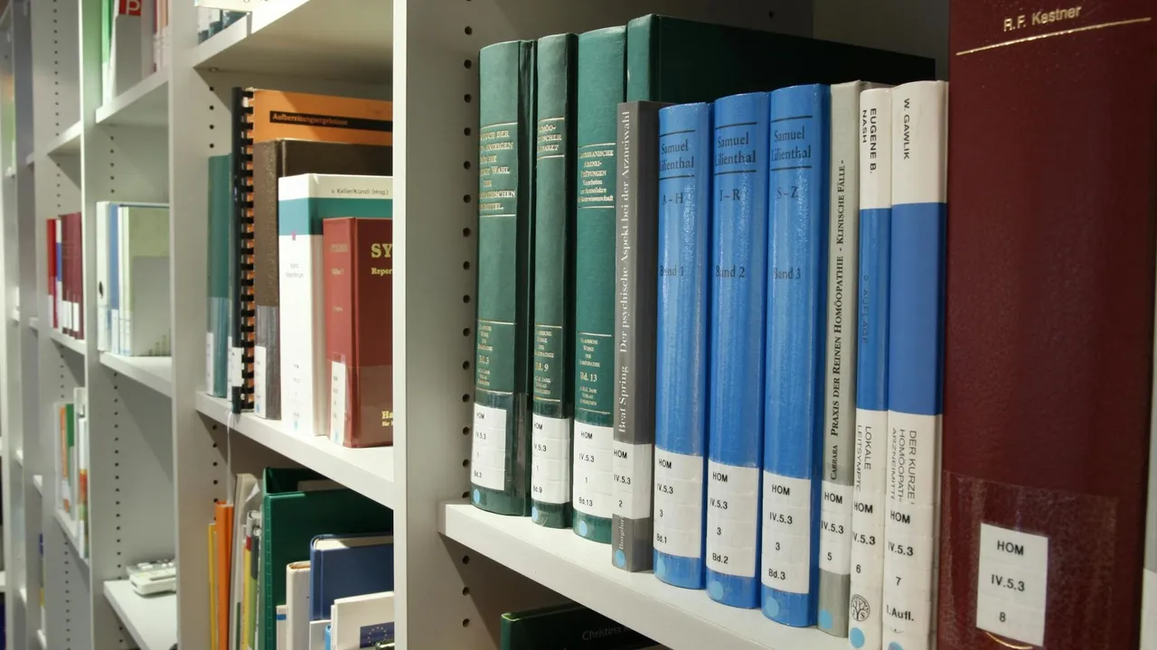Rows of green and blue hardcover mystery and crime thriller novels on a library shelf.