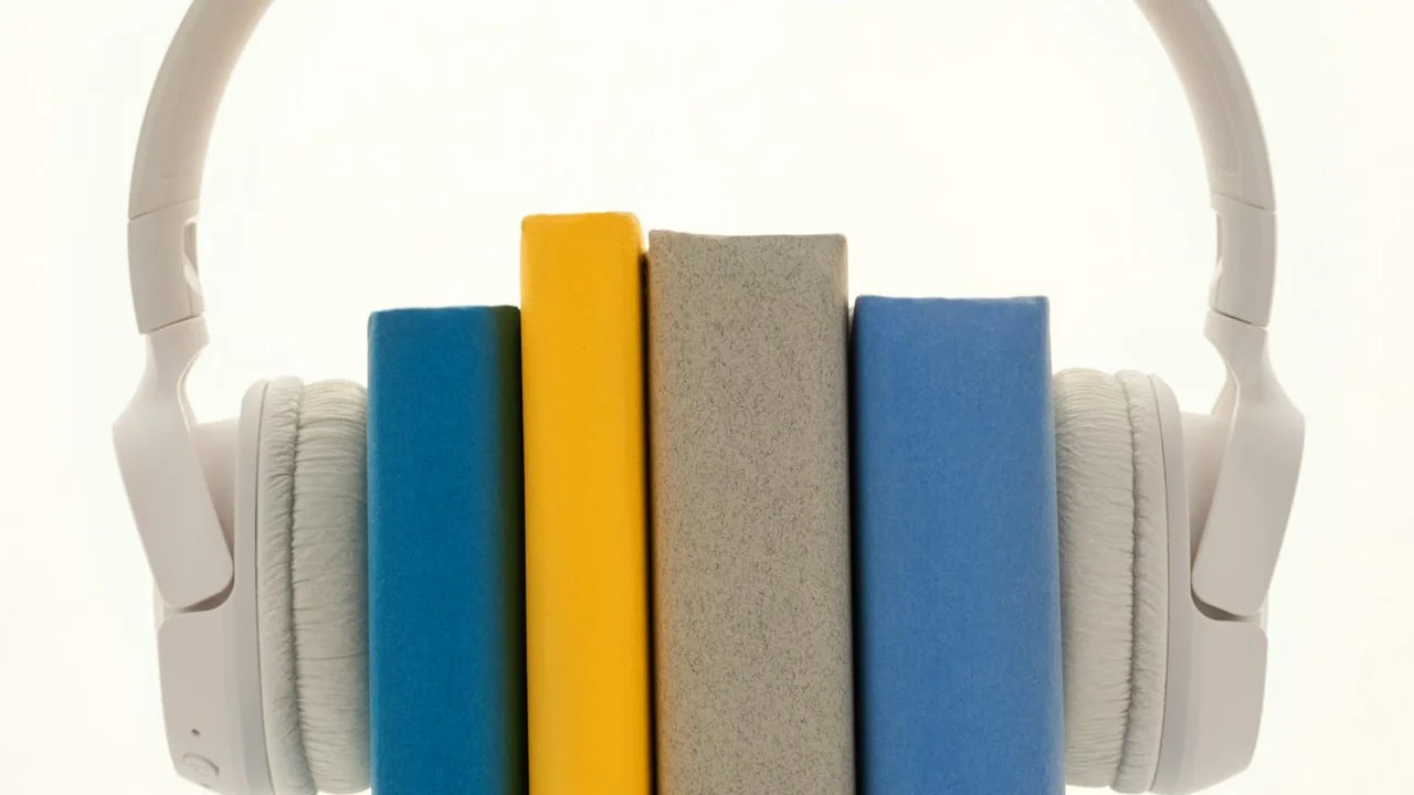 White over-ear headphones surrounding a row of colorful rectangular blocks arranged upright in blue, yellow, gray, and light blue