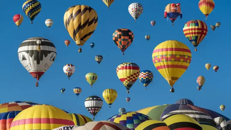 A sky filled with colorful hot air balloons floating above a landscape, creating a sense of adventure.