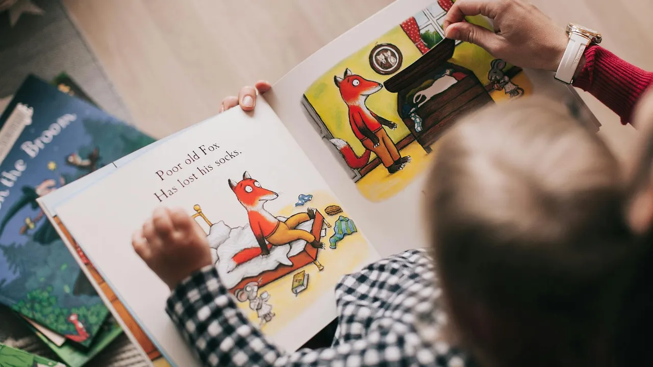 Two children exploring a colorful picture book with animal illustrations, discussing the pages.