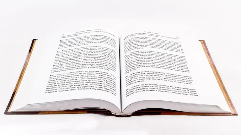 An open hardcover book with pages spread wide on a white background.