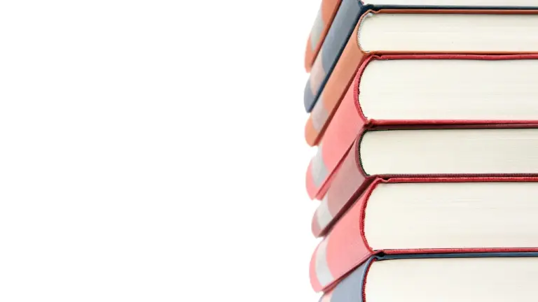 A stack of hardcover books stacked on the right side against a white background.