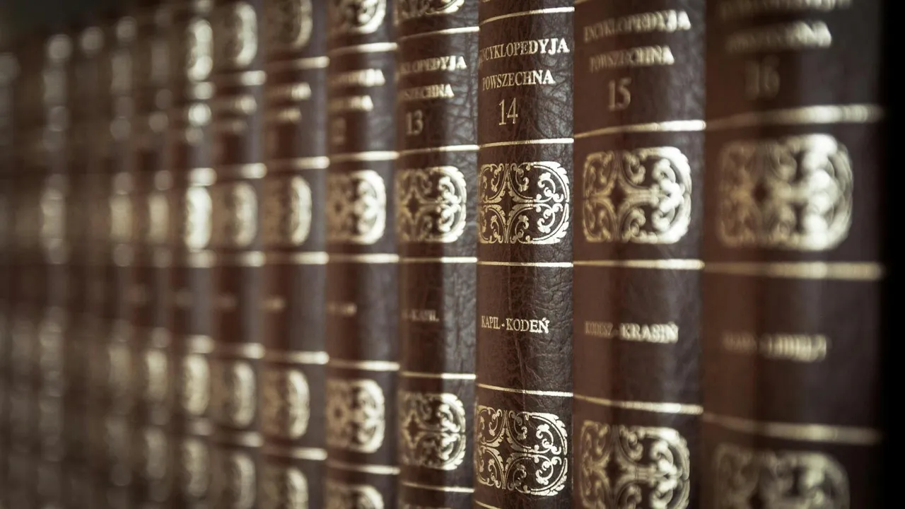 Leather-bound books with ornate gold embossing on a library shelf