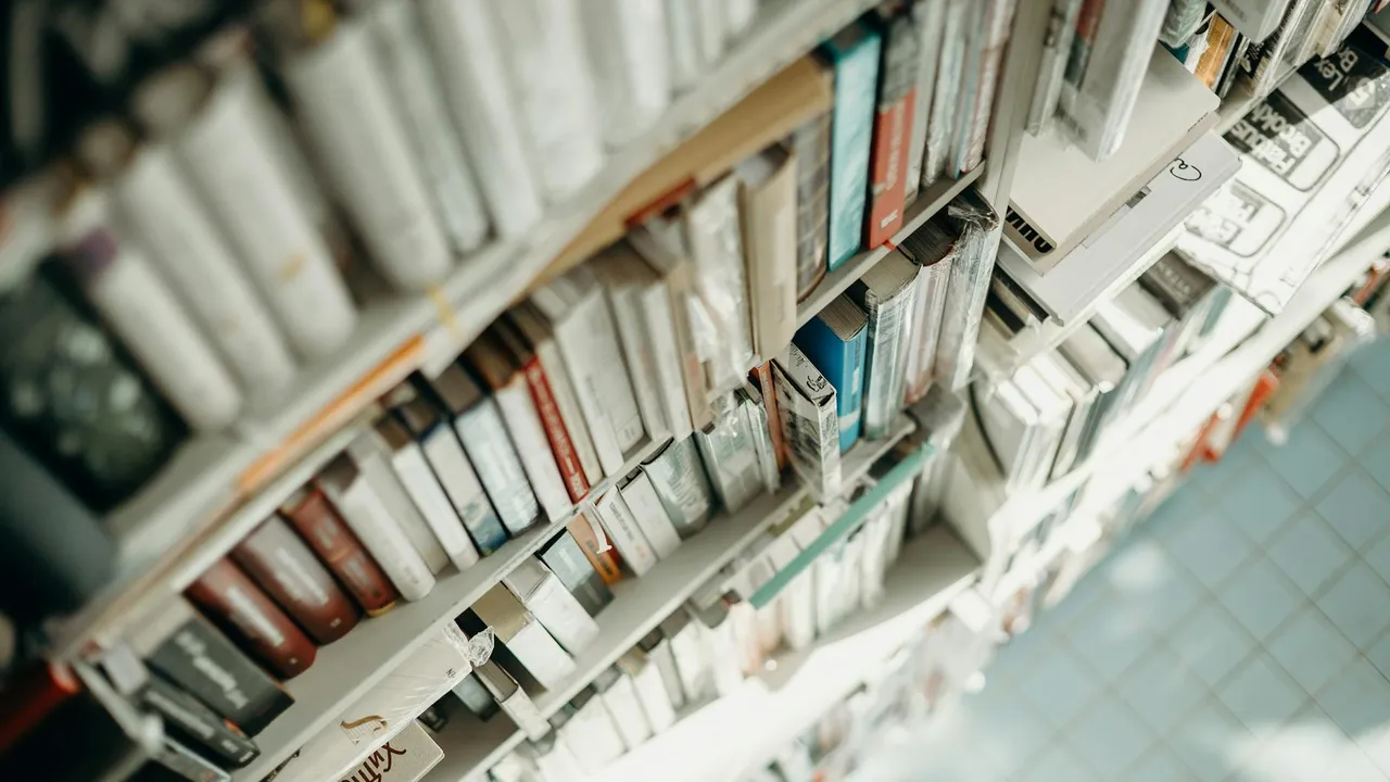 Overhead view of library shelves filled with rows of books, slightly blurred at the edges